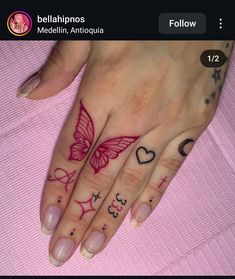 a woman's hand with tattoos on it