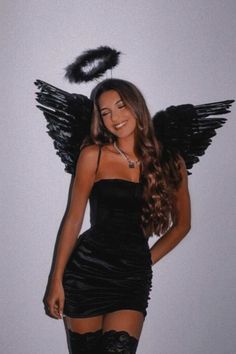 a woman in a black dress and angel wings