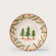 a plate with pine trees and berries on the rim, painted in red and green