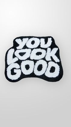 a black and white patch with the words you look good on it