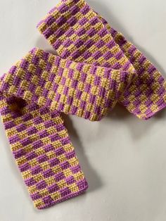 This is a purple and yellow checkered scarf. It is crocheted out of acrylic yarn and will keep you warm during the fall and winter while staying trendy. Checkered Scarf, Balloon Dog, Acrylic Yarn, Scarf Wrap, Violet, Scarf Accessory, Yarn, Etsy Accessories, Yellow