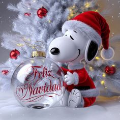 a christmas ornament with a snoopy dog in front of a tree