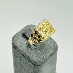 The Classic square nugget ring. Our nugget ring is crafted in 10K solid gold so you feel the weight. The nugget design runs down both sides of the ring to provide a full look. This is a must have any jewelry collection. This nugget ring is 12mm wide at the top. Gold Nugget Cluster Ring In 14k, 14k Gold Nugget Diamond Ring, Fine Jewelry 14k Gold Nugget Ring, Classic Gold Nugget Ring, Classic Yellow Gold Nugget Ring, 14k Gold Nugget Jewelry Gift, Natural Gold Nugget, The Nugget, Picture Pendant