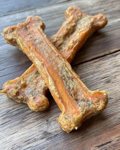 two raw dog bones on a wooden table