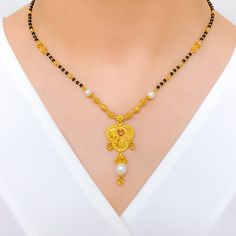 PRODUCT DETAILS Gold Purity(karat): 22k Item Weight(grams): 14.6 Item Finish: Yellow Gold Stone: Black Bead + Pearl Necklace Length: 18.5" Drop Length: 1.5" Adjustable Links: ﻿1.6" Lock Style: Hook Lock Gold Pearl Necklace With Black Round Beads, Elegant Black Temple Necklace For Festive Occasion, Elegant Black Temple Necklace For Wedding, Black Necklace With Intricate Design For Festivals, Black Necklaces With Intricate Design For Festivals, Black Intricate Design Necklace For Festivals, Elegant Black Temple Necklace As Gift, Elegant Black Beaded Jewelry For Puja, Elegant Black Temple Necklace Gift