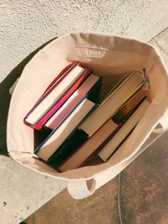 a bag full of books sitting on the ground