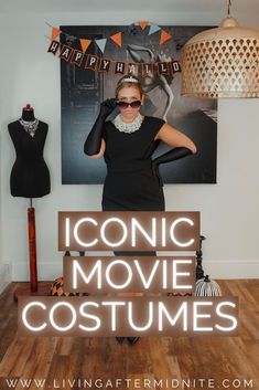 a woman standing in front of a poster with the words comic movie costumes on it