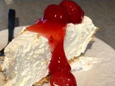 a piece of cheesecake with cherries on top