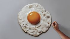 an egg being painted on the side of a wall