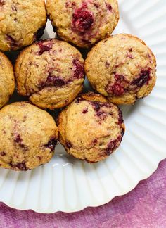 muffins on a plate with blueberries and cranberry sauce in the middle