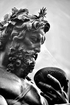 black and white photograph of a statue holding a frisbee