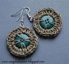 the earrings are made from woven material and have turquoise colored beads on each earring