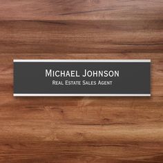 a real estate sales agent business card on a wooden table with the name michael johnson