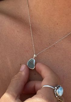 Make a splash and add some shore-inspired style to your wardrobe! Our handmade Sea Glass Necklace is perfect for any lover of the beach. Capture the beauty of a summer day and keep those good vibes at your fingertips all year round. Sea glass (5mm - 15mm) White gold-plated 100% sterling silver base Nickel-free Hypoallergenic Tarnish-resistant Pearl clasp 18" chain 2" extender Ocean safe Made in the USA *Please note: Each pendant varies in size, shape, and color shade. The Salty Gem is a Californ Silver Necklaces Pendant, Unique Silver Necklaces, Silver Beach Jewelry, Beach Silver Jewelry, Cool Jewelry Unique, Seaglass Necklaces, Seaglass Jewelry, Beach Glass Necklace, Pearl Clasp