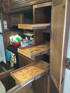 the inside of an rv with wood cabinets and drawers on each side that are open