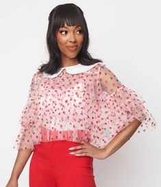 This sweet crop top is crafted in a fabulous pink sheer mesh that dances with red glitter hearts. The relaxed ruffled silhouette boasts a contrasting white Peter Pan collar and three-quarter length sleeves. Glamorous Mesh Top For Spring, Sheer Flirty Summer Tops, Flirty Sheer Summer Tops, Pink Fitted Tops For Valentine's Day, Pink Fitted Top For Valentine's Day, Glamorous Sheer Summer Tops, Summer Party Top With Heart Print, Red Mesh Top For Spring, Red Sheer Top For Spring