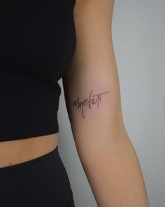 a woman's arm with the word comfort written on it in cursive writing