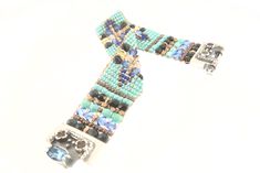 CHILI ROSE Blue Desert Cowboy Gemstone Bracelet Adonnah Langer hand looms Czech and Japanese seed beads with Czech fire-polished and brass beads woven into spectacular intricate designs Gorgeous Southwest pattern with stunning combination of Blue, Turquoise , Jet and a hint of Cornflower Perfect accent for Jeans & Tee! The end caps and clasp are all set sterling silver .925 with gemstones of Garnet-Citrine-Blue Topaz (All of which may be customized) -Bracelet measures as shown 6 3/4 inch end Traditional Blue Handwoven Beaded Bracelets, Artisan Blue Beaded Bracelets, Traditional Blue Jewelry With Bead Caps, Traditional Blue Bracelets With Spacer Beads, Artisan Blue Jewelry With Bead Caps, Artisan Blue Handwoven Beaded Bracelets, Blue Handwoven Bracelet, Desert Cowboy, Chili Rose