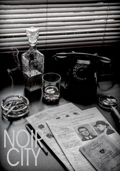 a table topped with glasses and papers next to a window