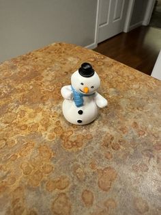 a snowman figurine sitting on top of a table