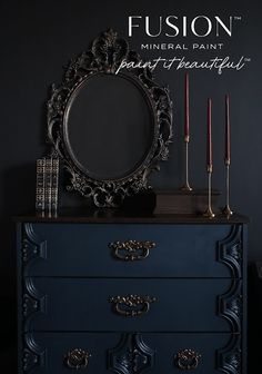 a black dresser with candles and a mirror on it's top that says fusion mineral paint