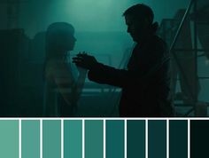 two people standing next to each other in front of green and blue color palettes