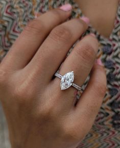 a woman's hand with a diamond ring on it