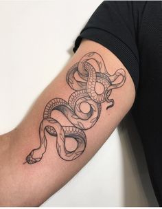 a man's arm with a snake tattoo on it