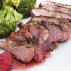 some meat and broccoli on a white plate