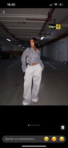 a woman standing in an empty parking garage