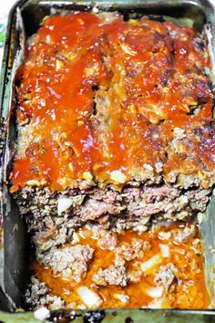 meatloaf casserole in a baking dish with sauce and cheese on top