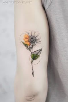 a woman's arm with a flower tattoo on it