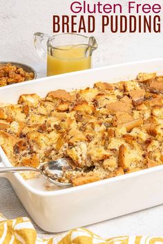 a casserole dish filled with bread pudding and topped with a spoon next to a glass of orange juice