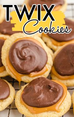 cookies with chocolate frosting and peanut butter on top are sitting on a cooling rack