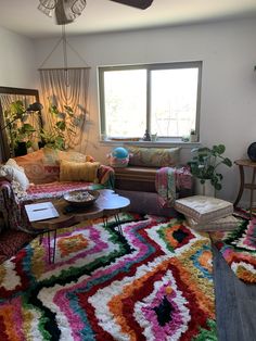 a living room filled with furniture and a colorful rug