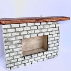 a brick fireplace with a wooden mantle and shelf in the middle on a white background