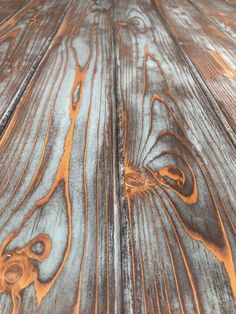 an old wooden table with peeling paint on it's woodgrain and some rust