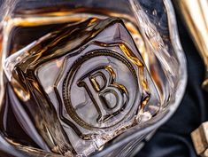 an ice cube with the letter b on it sitting in front of some other items