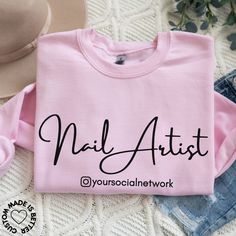 "Nail Artist Custom Shirt & Sweatshirt. Introducing our personalized \"Nail Artist\" tshirt, where creativity meets individuality! This cozy garment is crafted for those who transform fingertips into works of art, featuring the added touch of customization with your own RRSS. The stylish and impactful design pays homage to the artistry of nail styling, making it the perfect blend of fashion and personal pride. Whether you're in the salon creating stunning nail designs or simply want to showcase your passion for nail artistry, this sweatshirt is a warm and personal statement. Step into a world of style and individualized appreciation with our \"Nail Artist\" sweatshirt--it's more than just clothing; it's a personalized tribute to your creativity and expertise in the beauty industry. ☆ 50% c Nail Tech Shirts, Nails Tshirt, Vinyl T Shirts, Work Mugs, Retro Nails, Make Your Own Shirt, Stunning Nail Designs, Artist Business Cards, Nail Room