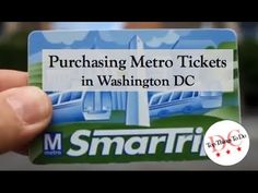 a person holding up a business card with the words purchasing metro tickets in washington dc