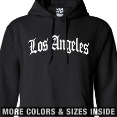 Los Angeles OE Arch HoodieOld English LA Hooded Sweatshirt - All Sizes & Colors. About Our Hoodies Shirt Boss uses Gildan for all of our shirts and sweatshirts. The size chart is an estimate, not all hoodies will be exact to these dimensions. The numbers listed are in inches, please allow up to a 1.5 inch difference either way in the width, length and/or sleeves. The chest is measure from armpit to armpit. Heavy Blend Hooded Sweatshirt Preshrunk 50% cotton/50% polyester • 7.75-oz. • air-jet yarn Black Top With Logo Lettering For Winter, Black Tops With Logo Lettering For Winter, Black Logo Lettering Top For Winter, Long Sleeve Hoodie With Logo Lettering For Streetwear, Streetwear Hoodie With Logo Lettering, Streetwear Long Sleeve Hoodie With Logo Lettering, Urban Style Letter Print Hoodie For College, Casual Cotton Hoodie With Logo Lettering, Streetwear Hoodie With Lettering