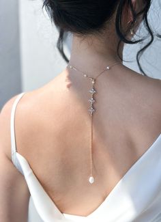 This romantic drop back chain is perfect for your backless bridal gown or evening dresses. Made from fresh water pearl and shinny zirconia charms. You can either choose a multiple pearl or single pearl choker style.  Matching earrings & bracelet: https://nikyglam.etsy.com/listing/1506173529 ♥Lead and nickel free ♥Made from shinny and high-quality cubic zirconia crystal  ♥Custom design and length possible ♥Handmade with love ♡JEWELRY DETAILS♡ 【Chain】 Length around neck: 40 - 45 cm / select length Elegant Cubic Zirconia Backdrop Necklace With Delicate Chain, Elegant Gold Crystal Lariat Necklace, Delicate Clavicle Chain Backdrop Necklace For Weddings, Crystal Clavicle Chain Backdrop Necklace For Wedding, Crystal Backdrop Necklace With Clavicle Chain For Wedding, Wedding Backdrop Necklace With Clavicle Chain, Elegant Crystal Lariat Necklace, Elegant Crystal Lariat Necklace With Clavicle Chain, Elegant Crystal Lariat Backdrop Necklace