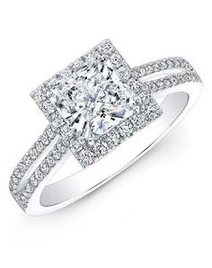 a diamond engagement ring with two rows of diamonds on the band and a square shaped center stone