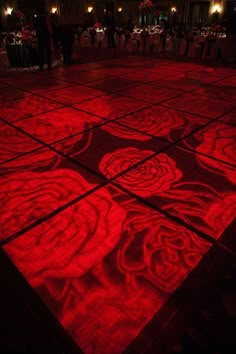 the dance floor is lit up with red lights