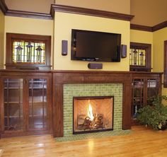 a living room with a fireplace and entertainment center