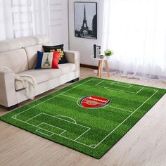 a living room with a soccer field rug on the floor and a couch in front of it