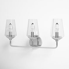 three light fixtures on a white wall