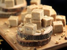 several pieces of tofu on a wooden cutting board