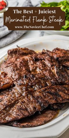 the best juicyest marinated flank steak on a white plate with lettuce and tomatoes