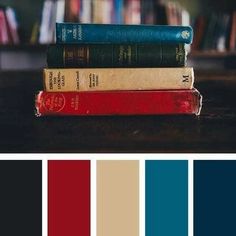 a stack of books sitting on top of each other in front of a book shelf